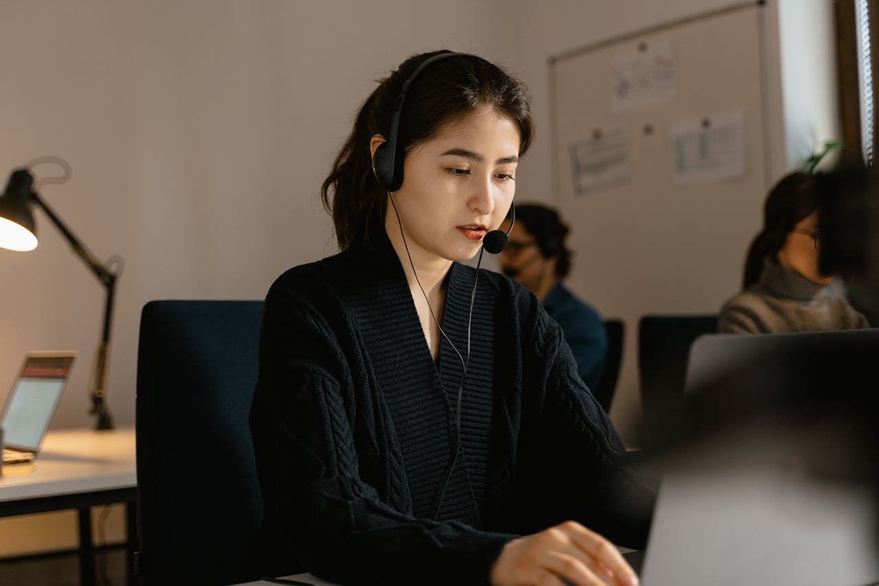 Woman in a Black Top Wearing a Black Headset Woman in a Black Top Wearing a Black Headset<br />